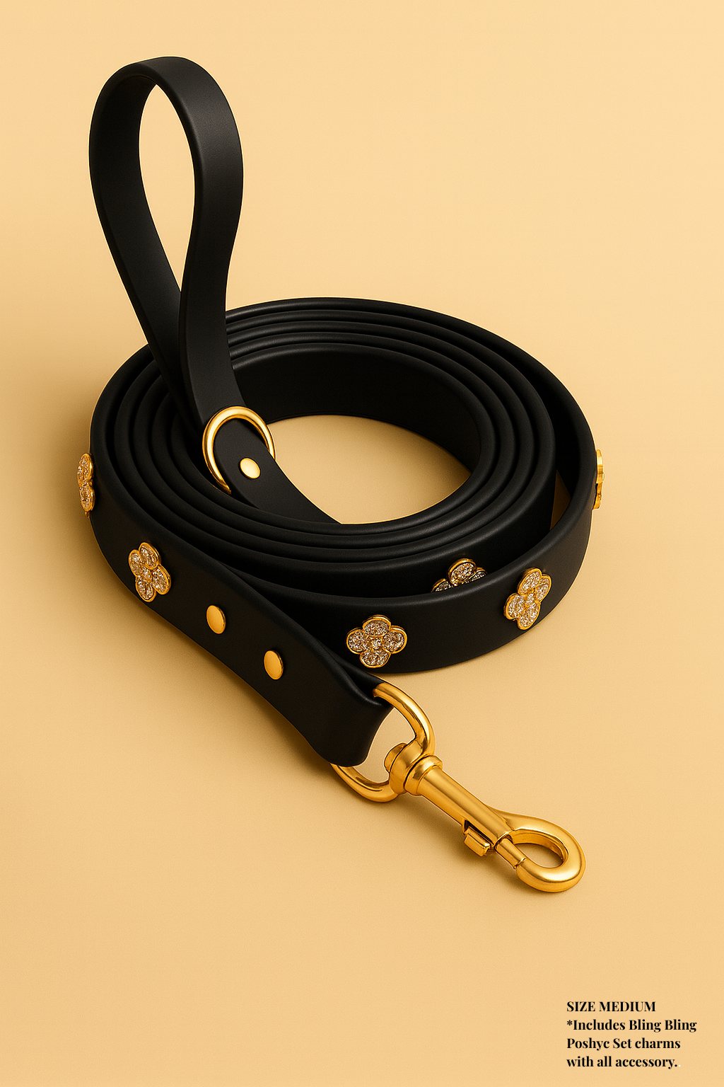 Black dog leash with gold hardware on a beige background